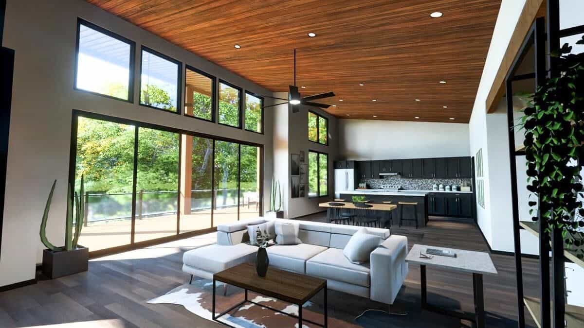 Combined living room and kitchen with hardwood flooring and a shed ceiling clad in wood planks.