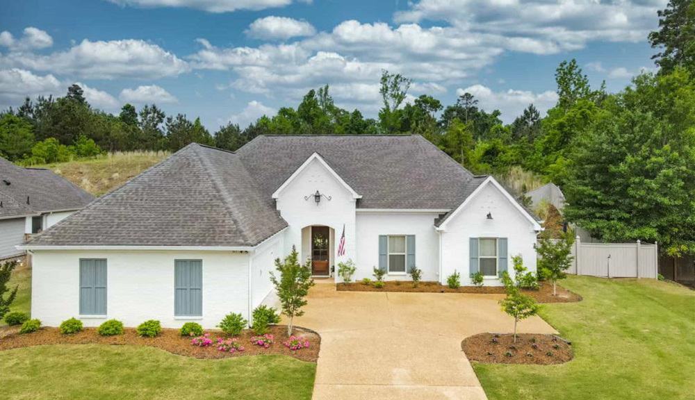 Single-Story Acadian Style 4-Bedroom Home with Open Living Area and Courtyard-Entry Garage