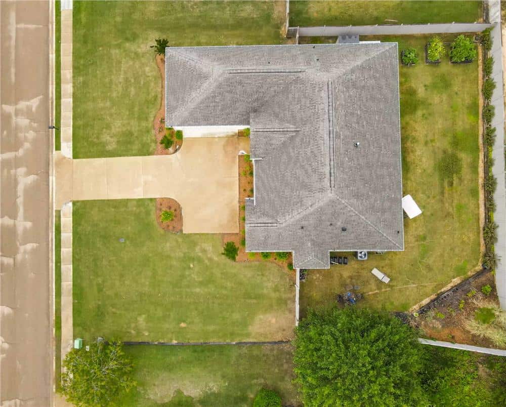 Aerial view of the Acadian home surrounded by lush lawns.