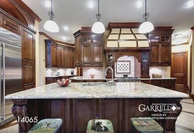 The kitchen offers natural wood cabinetry, stainless steel appliances, and a large island fitted with a prep sink.