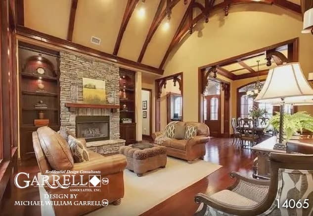 The lodge room has leather sofas, a stone fireplace, and a cathedral ceiling framed with exposed trusses.