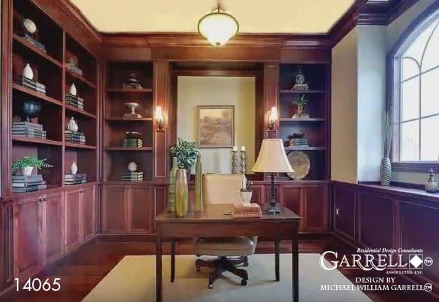 Study with built-in bookshelves and a wooden desk that blends in with the hardwood floor.