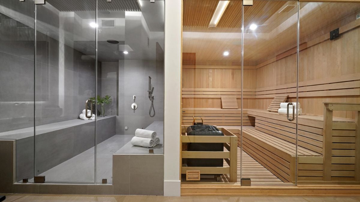 Experience the epitome of relaxation in this luxurious home spa, complete with an extra-large wet sauna, a shower featuring a rainhead, and a dry sauna.