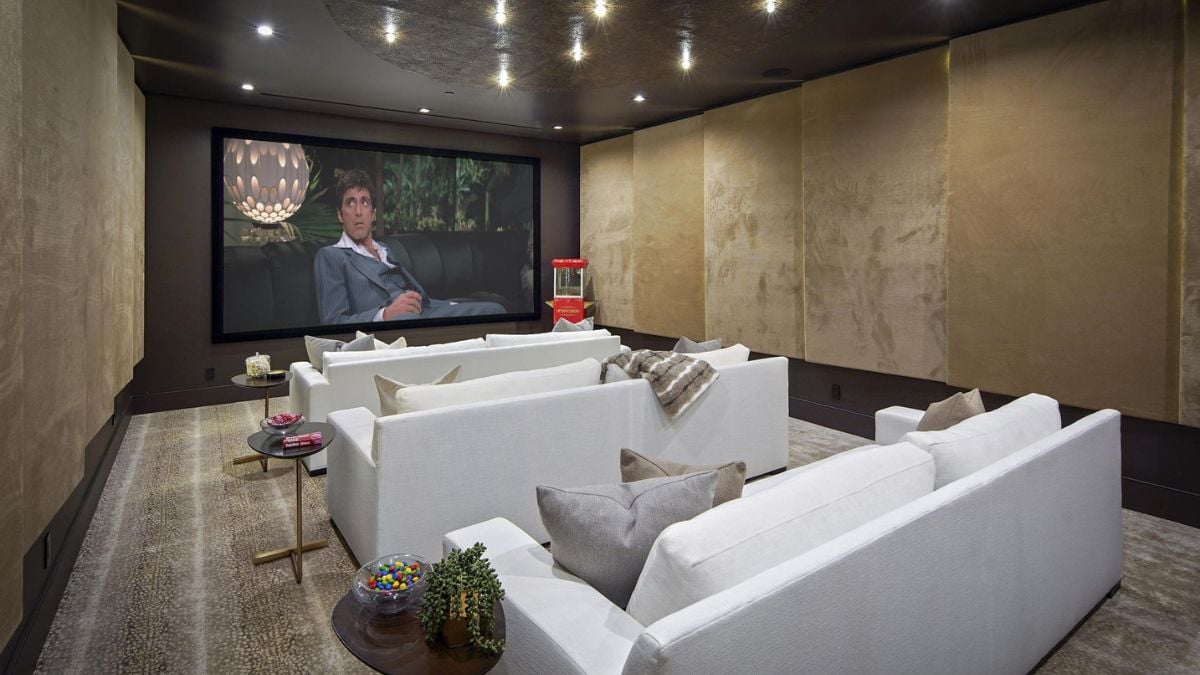 A cinematic experience within the Dolby Home Theatre, where upholstered acoustical wall panels, laser-cut ceiling panels, and plush carpeting.