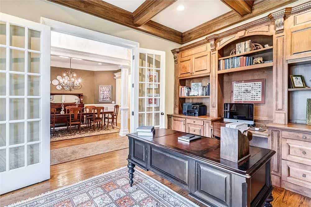Study with a coffered ceiling, built-in cabinets, and a dark wood desk.