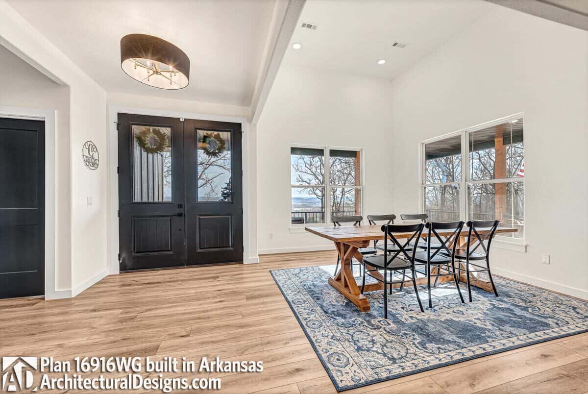 The dining room features a wooden dining set sitting on a vintage area rug.