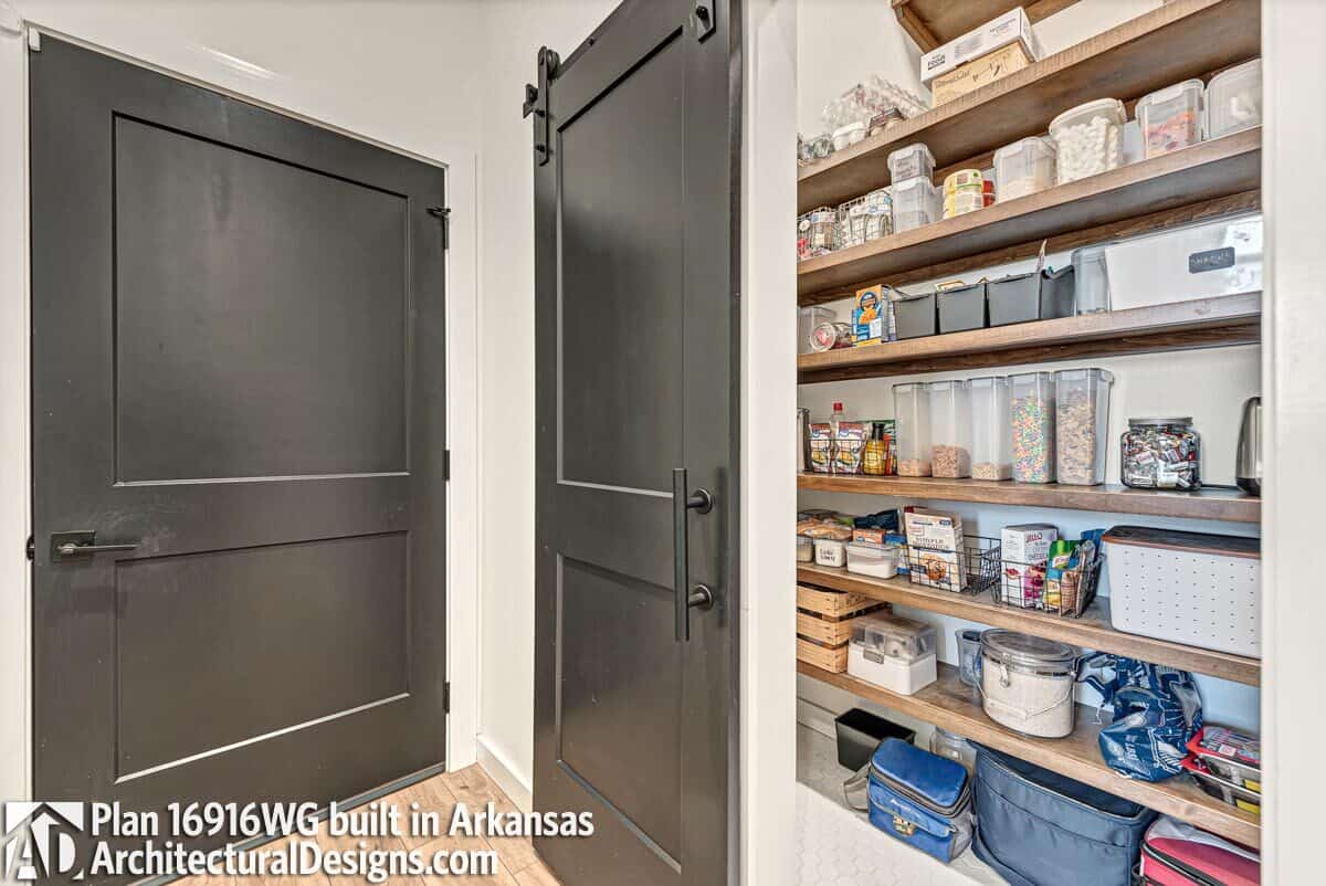 A sliding barn door reveals the walk-in pantry.