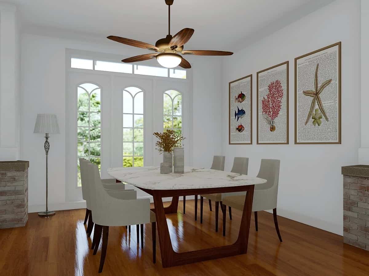 Formal dining room with a marble-top table, contemporary armchairs, and tall windows overlooking the front yard.