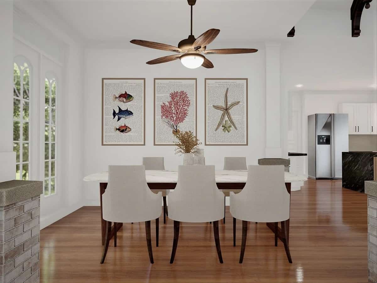 Framed artworks fixed against the white walls adorn the formal dining room.