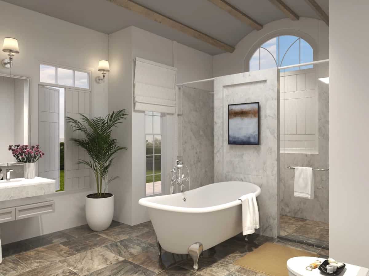 The primary bathroom offers a spacious walk-in shower and a clawfoot tub under a barrel-vaulted ceiling.