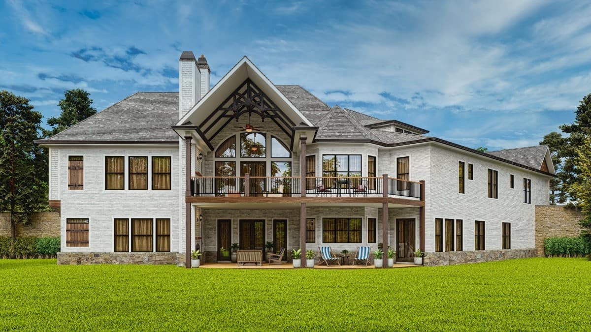 View of the house from the backyard showcasing its expansive porches and a multitude of windows bringing abundant natural light in.