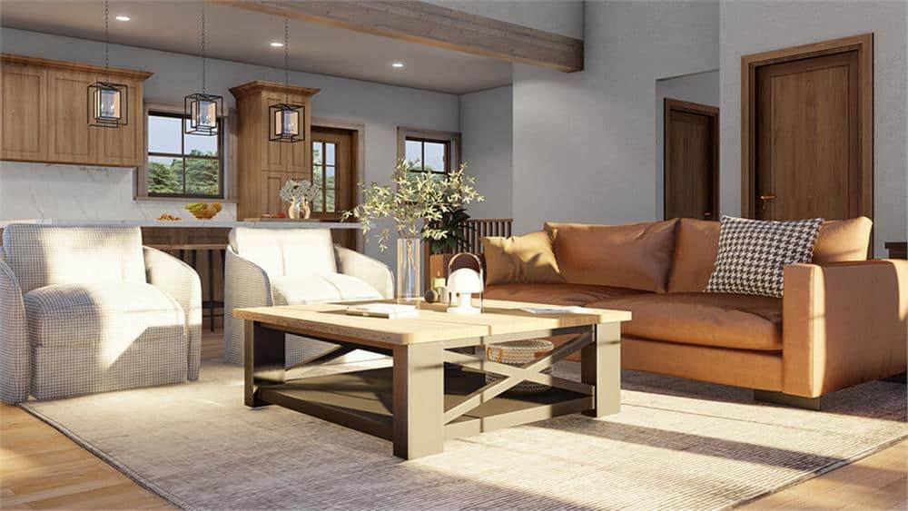 Great room with a leather sofa, gray armchairs, and a wooden coffee table over a distressed area rug.