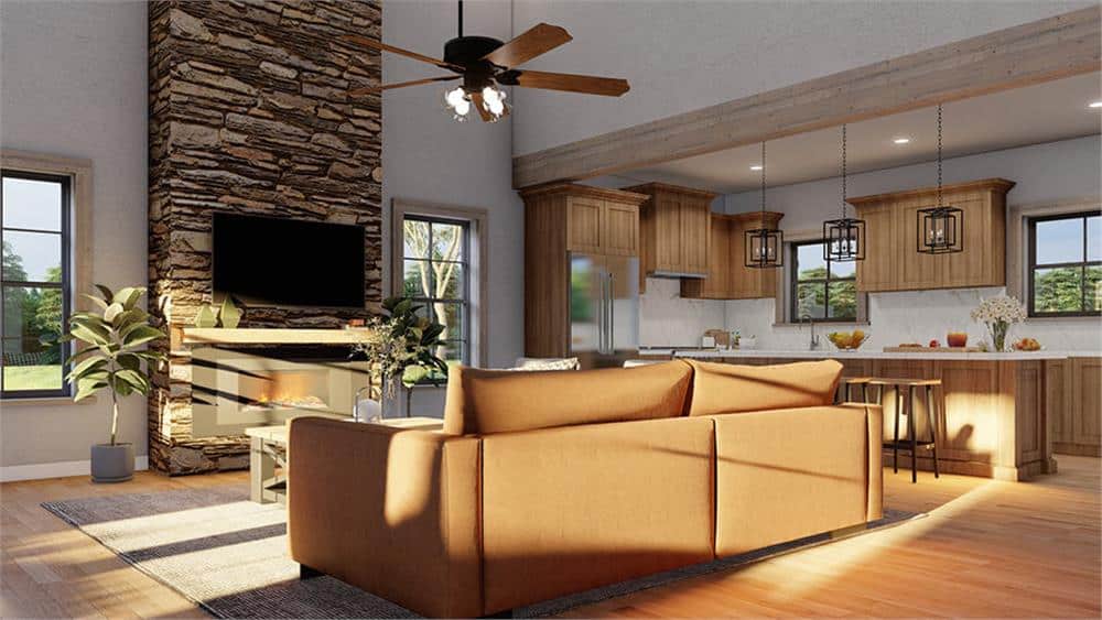The great room includes a stone fireplace topped with a TV.