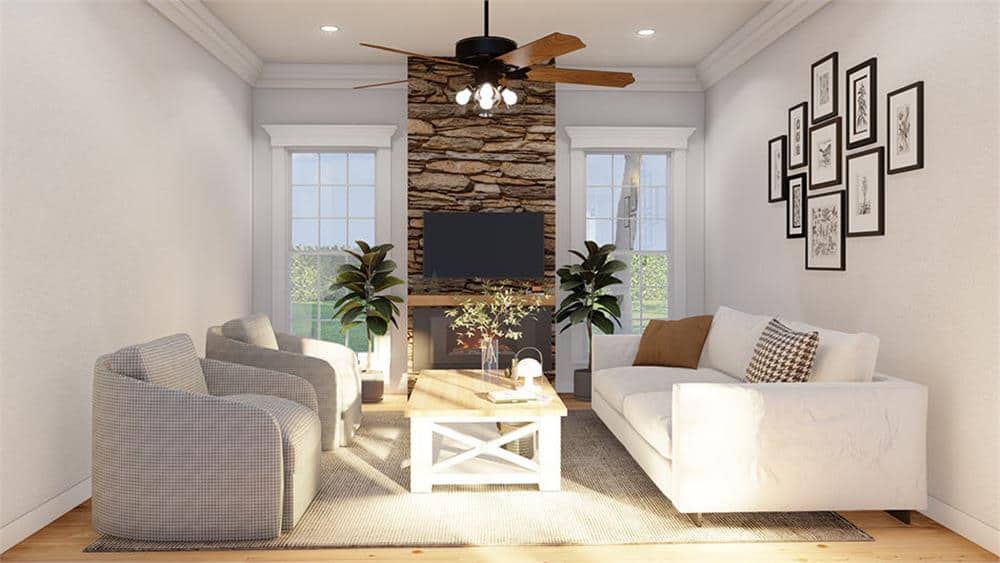 The great room has modern seats and a stone fireplace flanked by tall windows.
