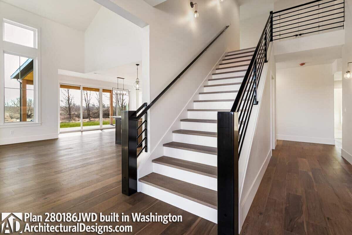 Foyer with a staircase and a view of the open living space.