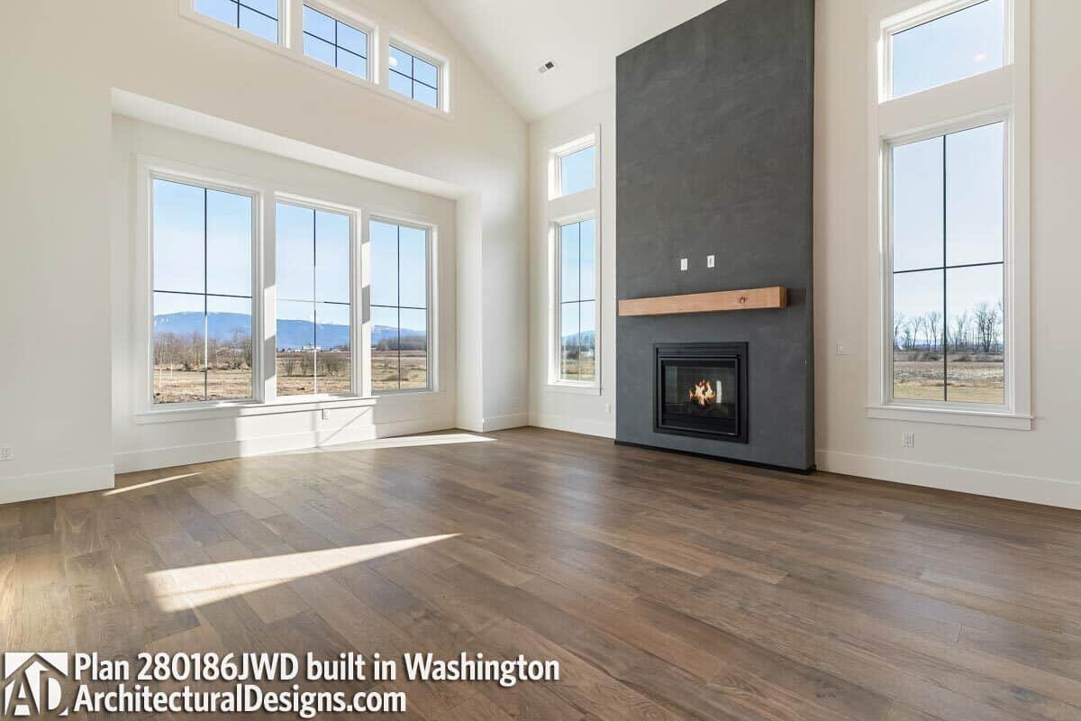 The great room has a fireplace, a vaulted ceiling, and plenty of windows bringing abundant natural light in.