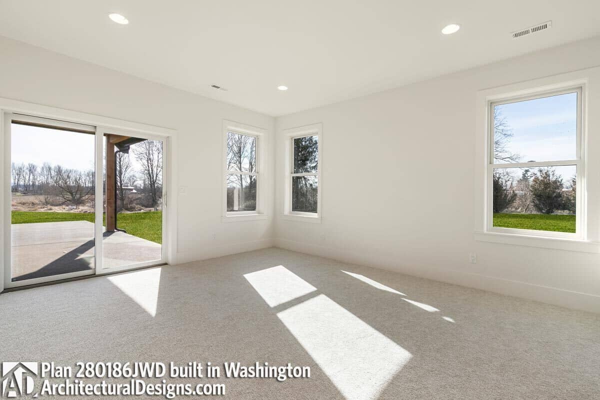 The primary bedroom has carpet flooring and direct access to a covered patio through glass sliders.