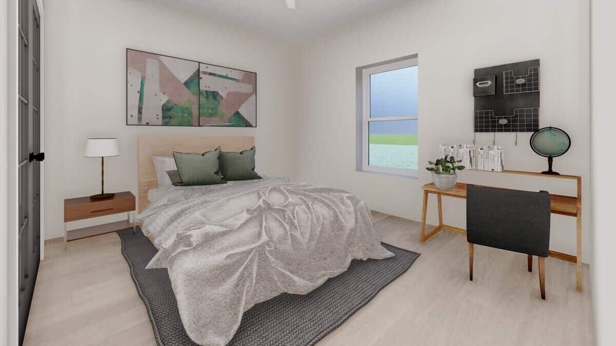 The primary bedroom has light hardwood flooring and beige walls adorned by abstract artworks.