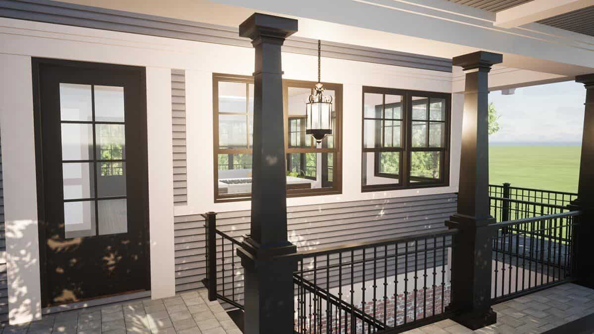 The entry porch has a glazed front door, tapered columns, and wrought iron railings.