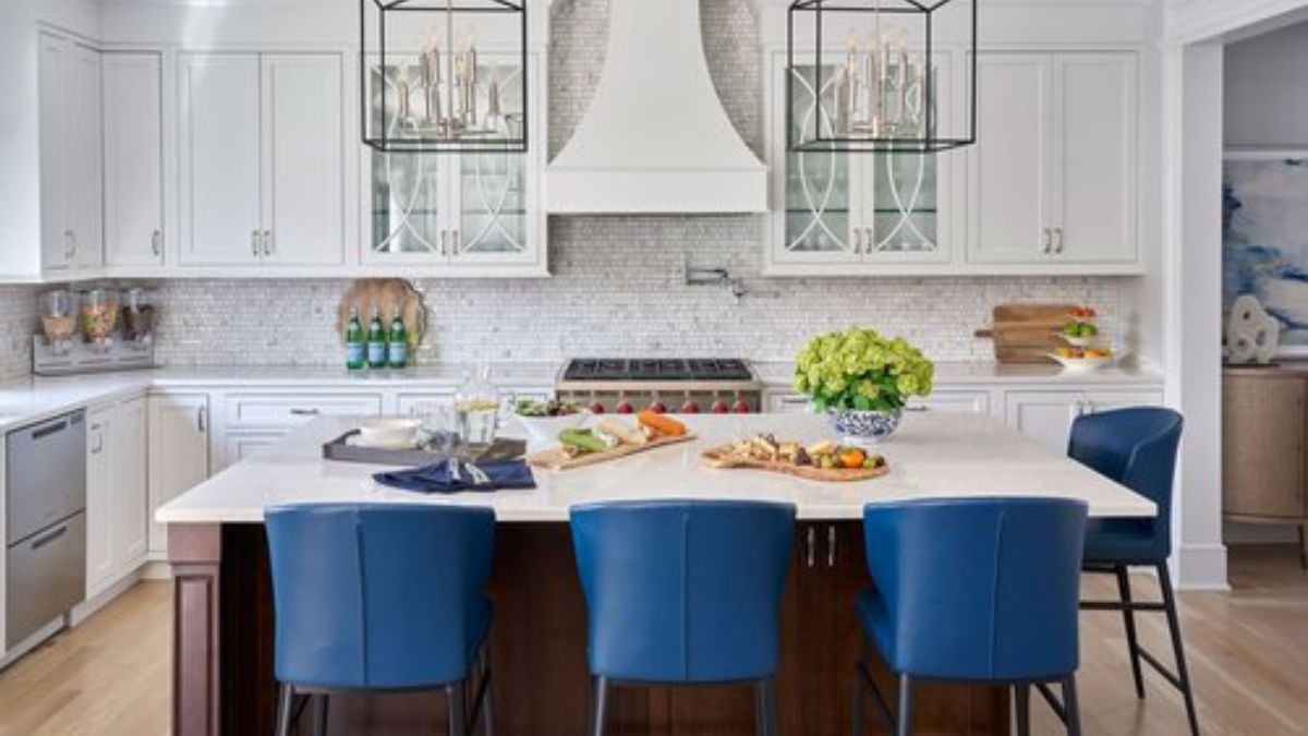 This image displays a kitchen in the background and an island counter for informal dining.