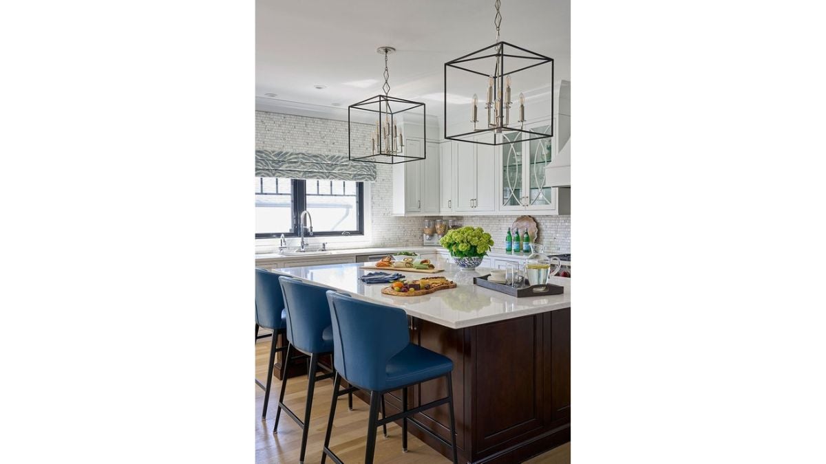 Three seats at the island counter are blue to go with the house's decor.