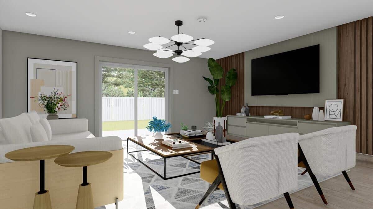 The family room includes a large TV mounted against the wood-paneled wall.
