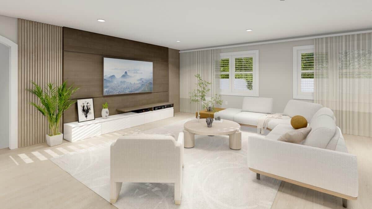 Family room with modern seats, a round coffee table, and a TV mounted above the built-in console table.