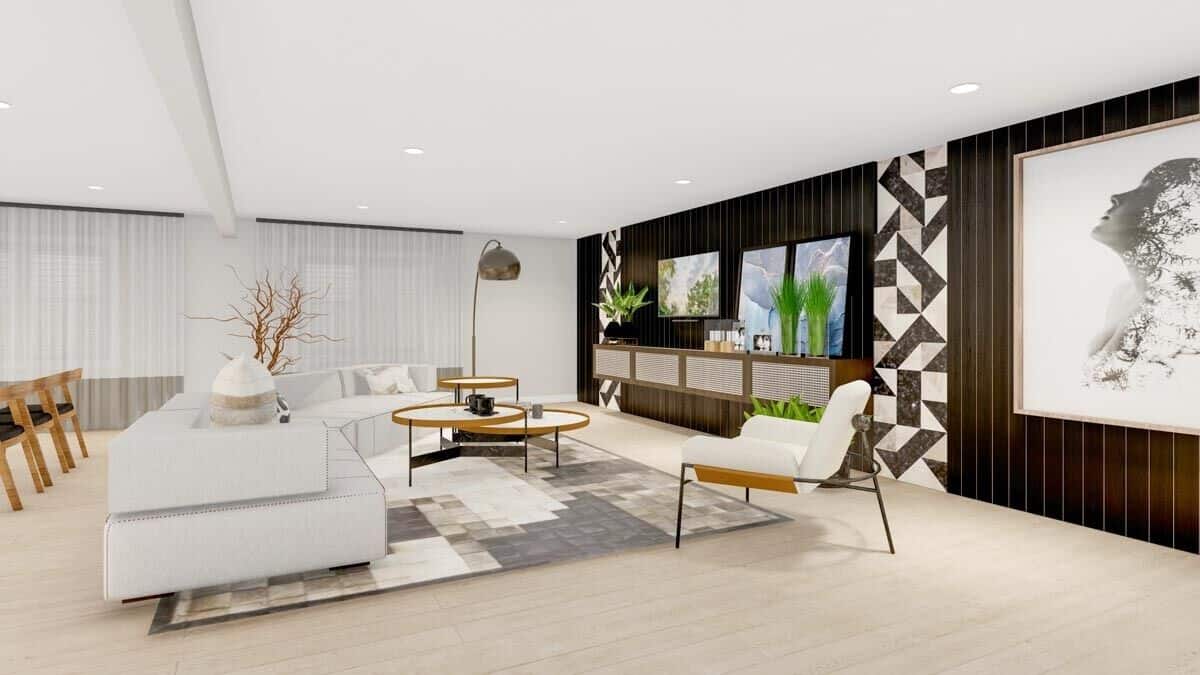 Lower-level family room with a wall-mounted TV, a curved sofa, and nesting coffee tables over a checkered area rug.