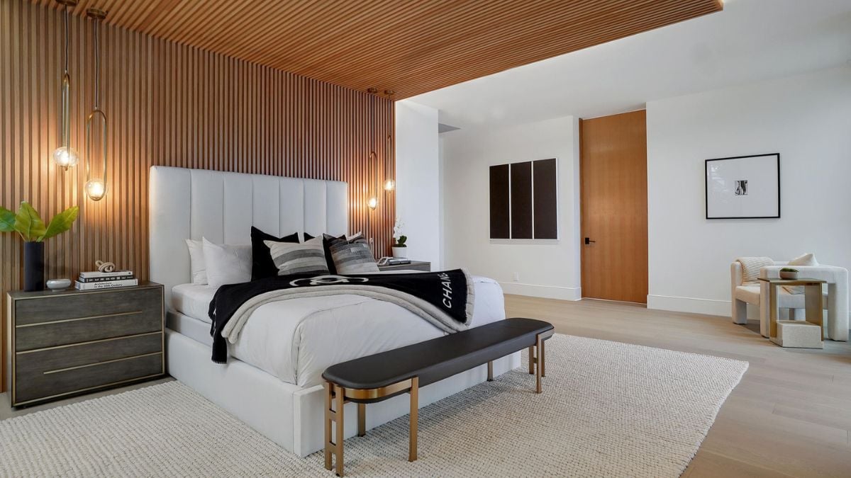 Indulge in the ultimate retreat space of the Primary Bedroom Suite, complete with a sitting area, floor-to-ceiling windows, a fireplace, and a private terrace offering views of the backyard pool.