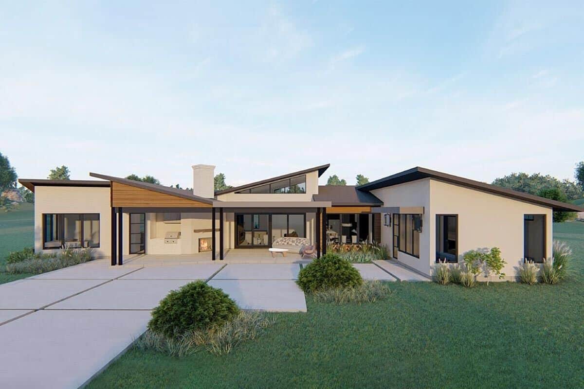 Rear rendering with concrete patio and a covered porch warmed by an outdoor fireplace.