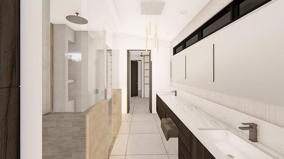 The primary bathroom features an elongated island with two sinks and a makeup counter.