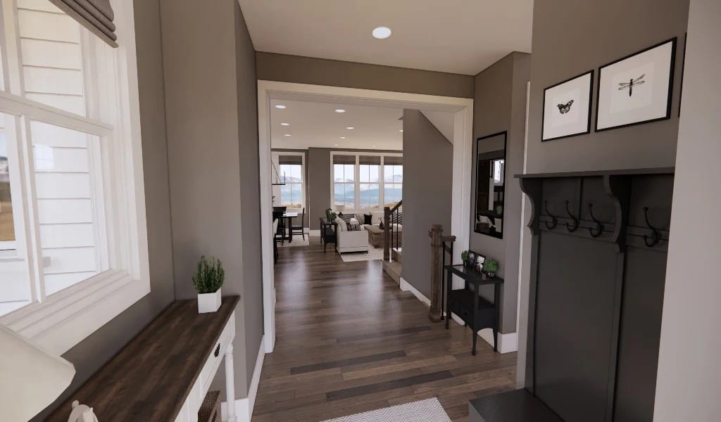 The foyer has a coat closet, a wooden console table, and a view of the open living space.