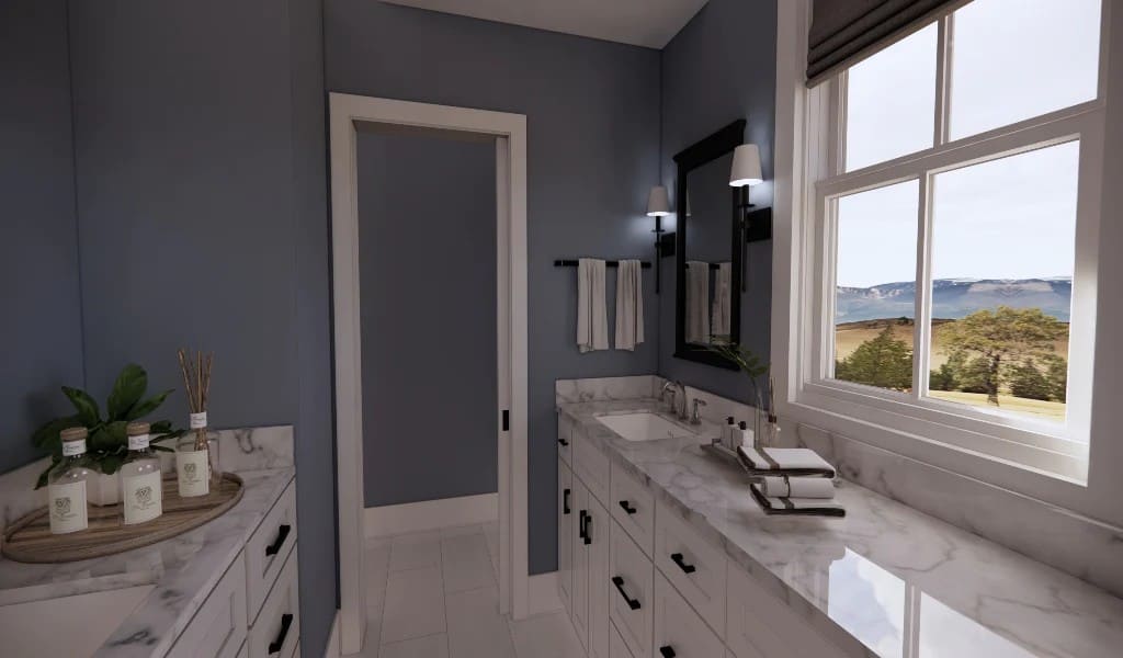 The primary bathroom features light blue walls and separate his and her vanities with marble counters.