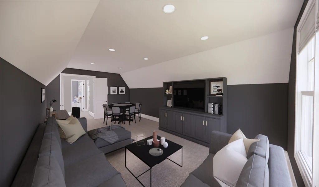 Bonus room with a game table and a large sofa under a vaulted ceiling.