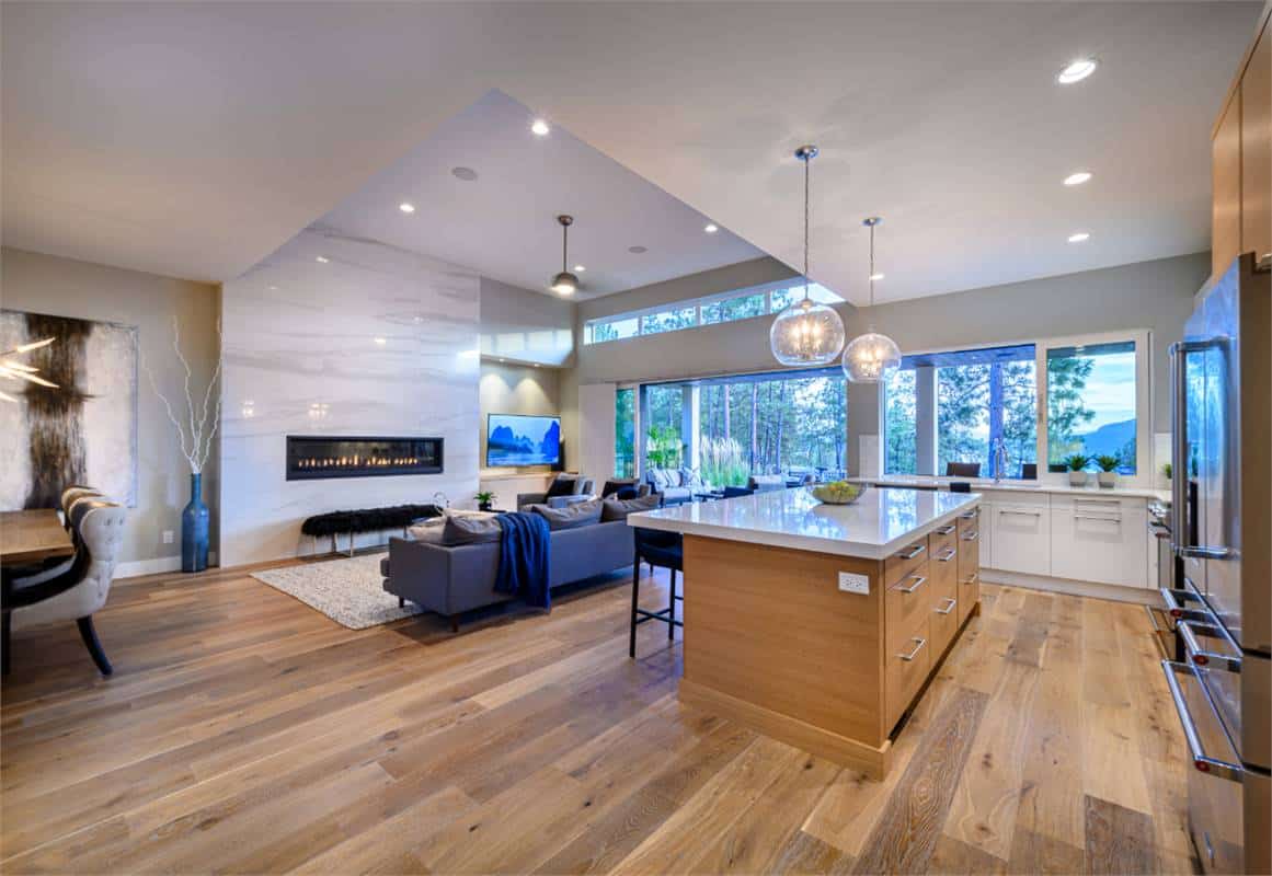 A rear wall of windows floods the open living space with abundant natural light.