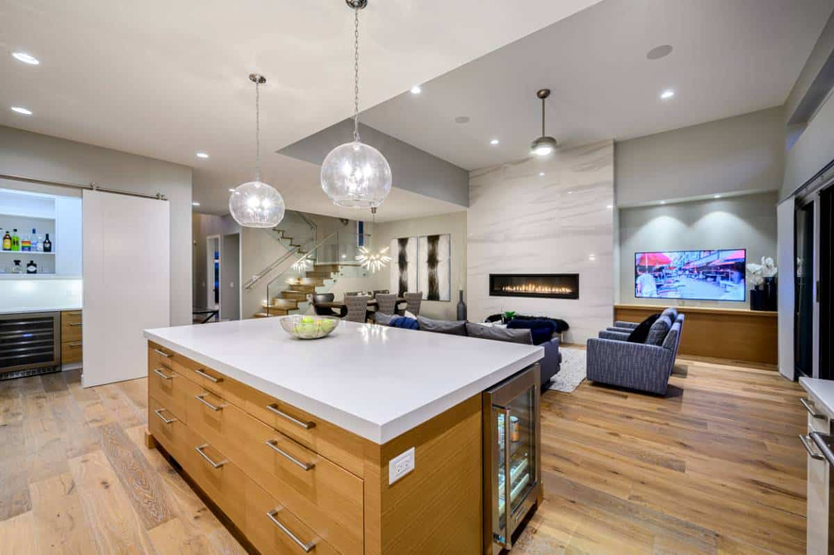 A large marble fireplace sets an elegant focal point in the open living space.
