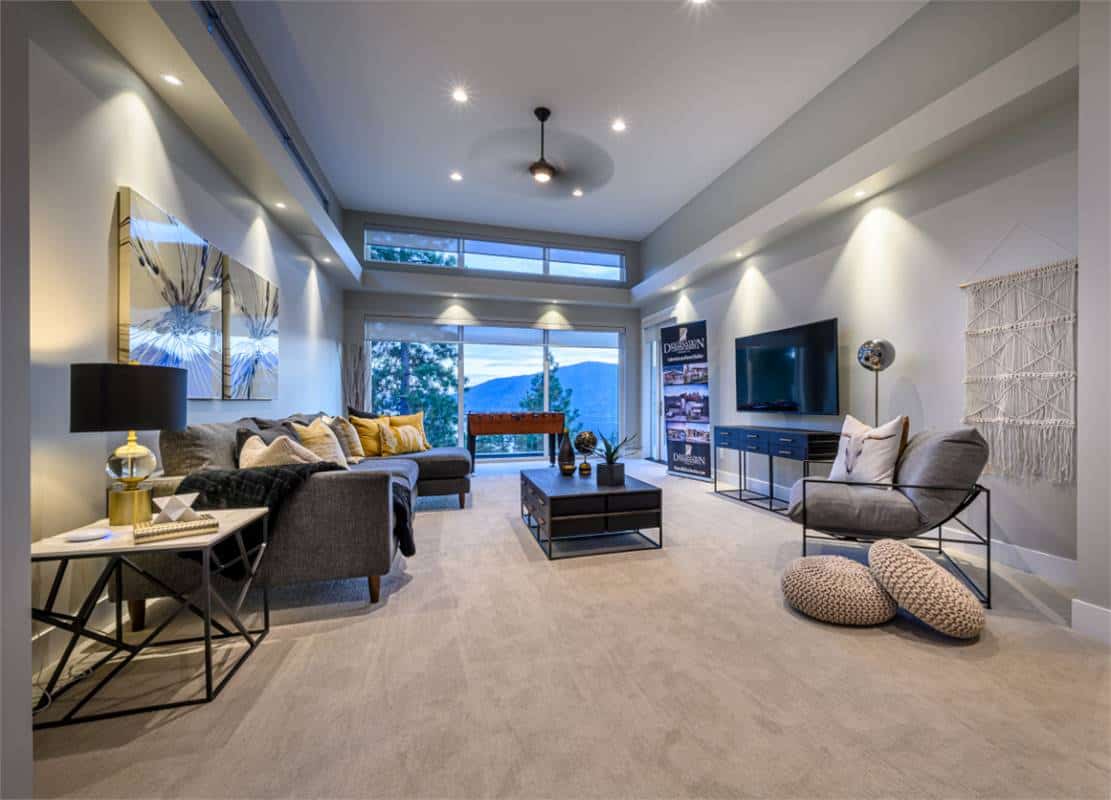 Spacious recreation room with carpeted floor and massive windows that take in ample natural light and spectacular views.