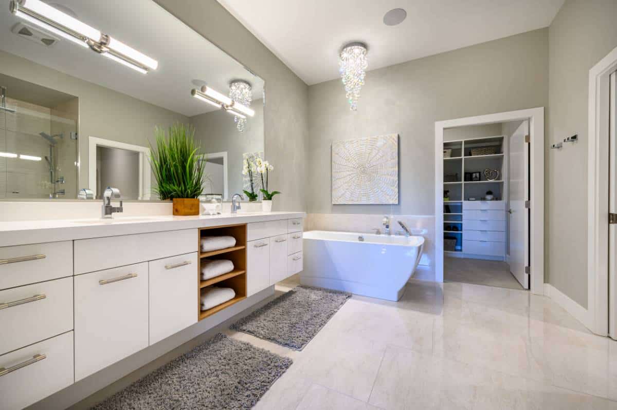 The primary bathroom is equipped with a dual sink vanity, a soaking tub, and a walk-in closet.