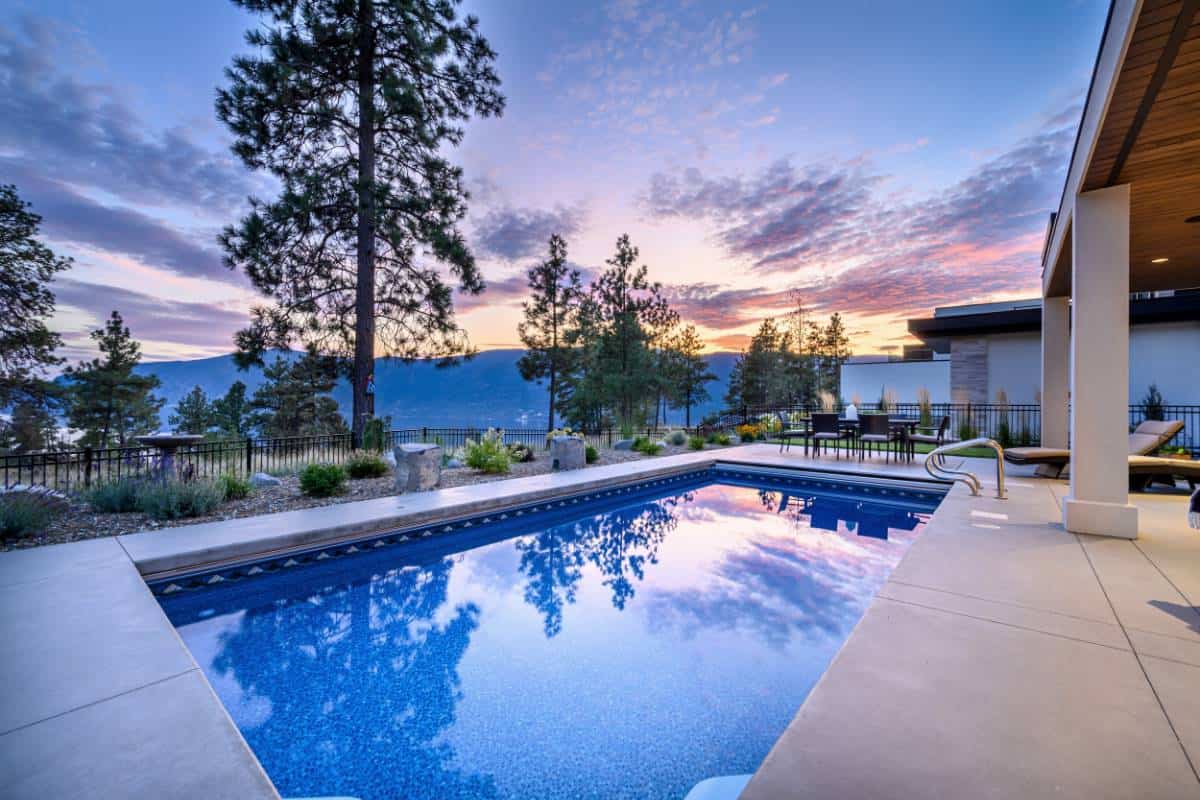 The covered deck is complemented by a sparking pool.