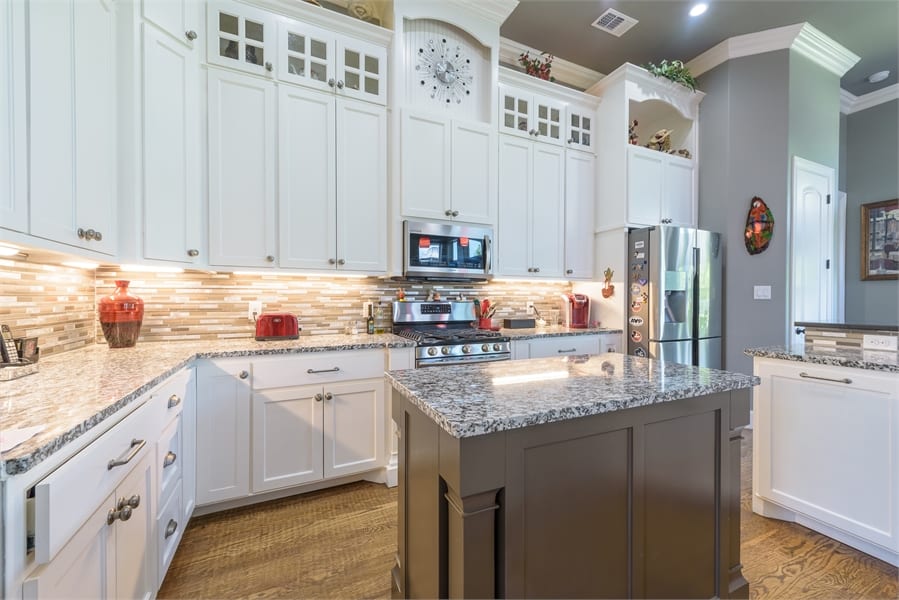 The kitchen is equipped with modern appliances, lots of storage, and a center island.