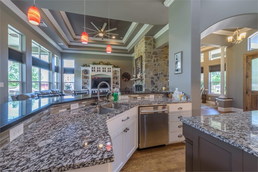 The kitchen includes a curved eating bar overlooking the family room.