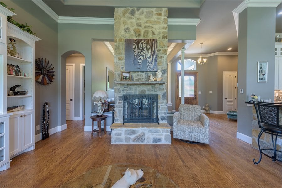 The family room includes a double-sided fireplace shared by the dining room.