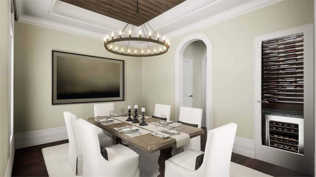 Formal dining room with a 6-seater dining set and a round chandelier that hangs from the tray ceiling.