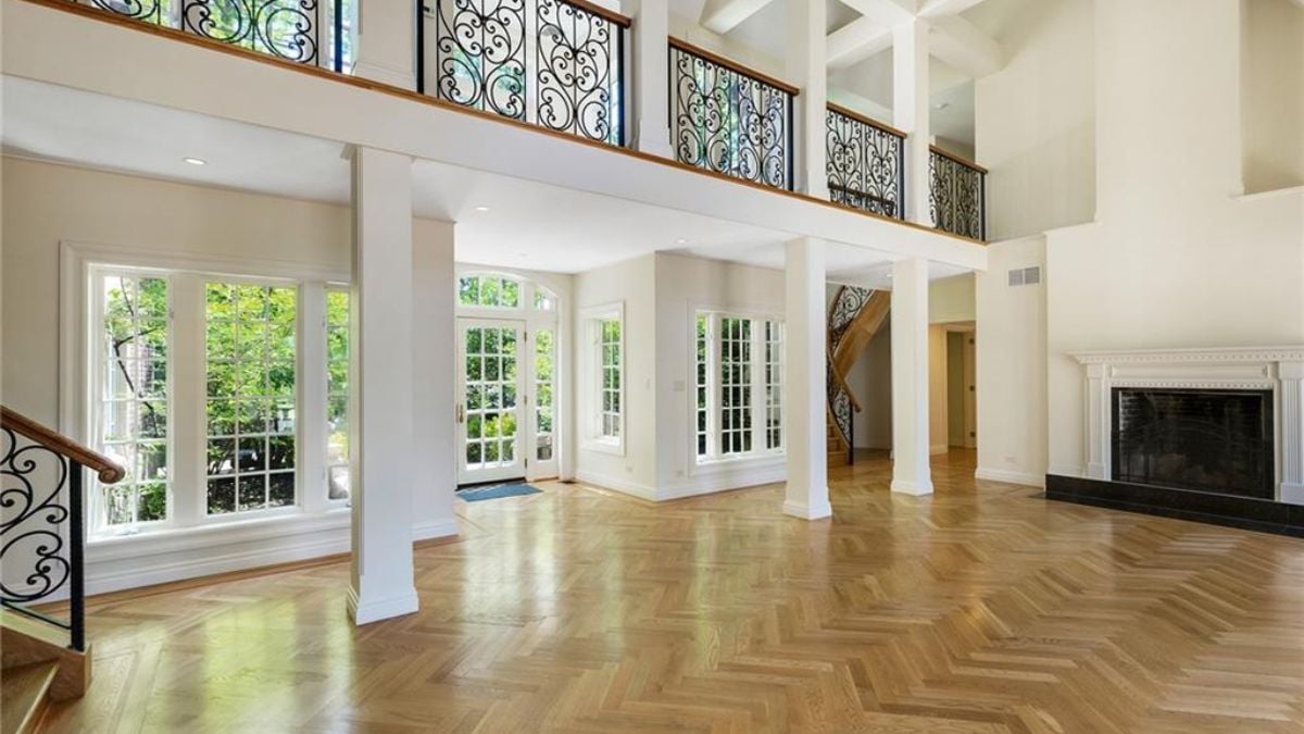 The main entrance of the mansion with white paint and modernized fireplace.