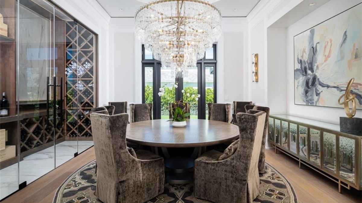 A space designed to get people together on a nice fabric chair and classic chandelier above.