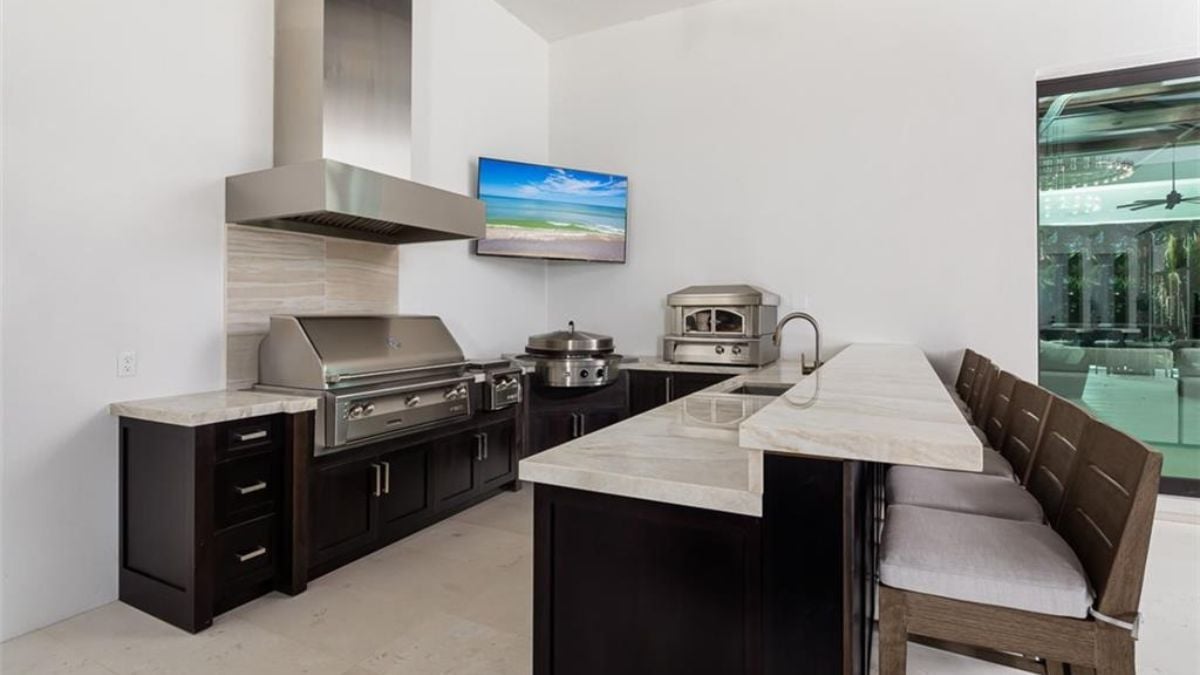 A modernized kitchen with television and proper vevntilation for cooking.