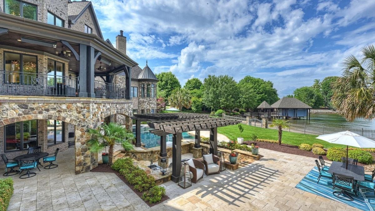 The veranda, patio, and sun-shade sails beside the pool