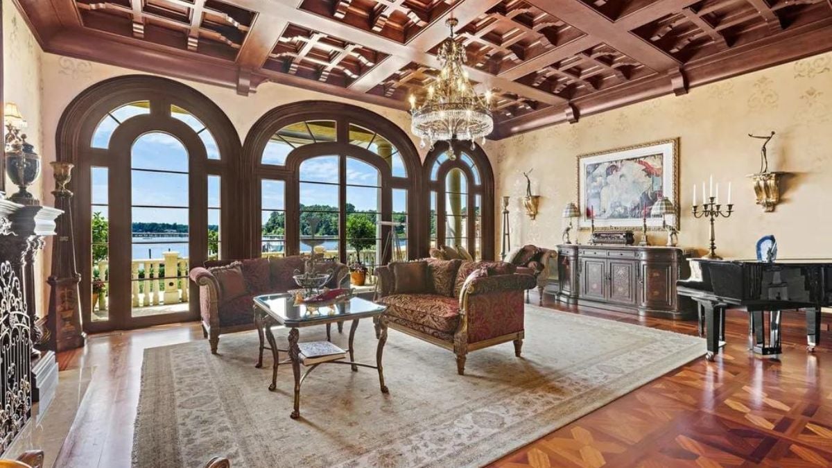 Living area with classic hearth and chandelier.