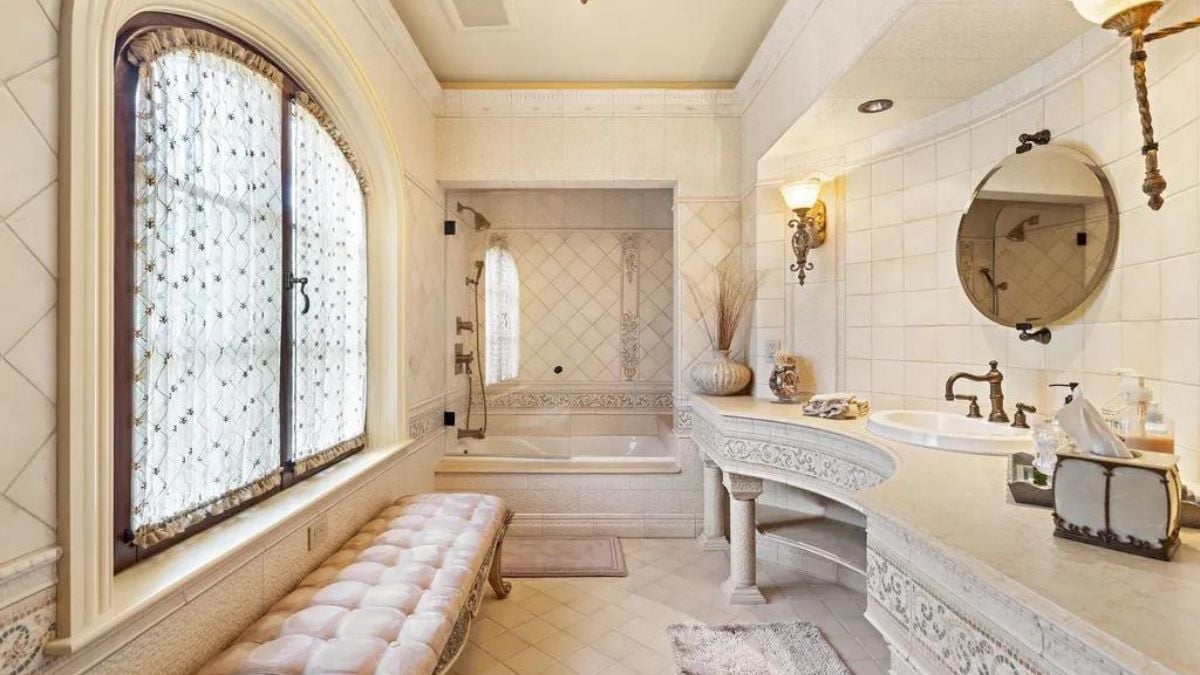 White-themed bathroom with tub.