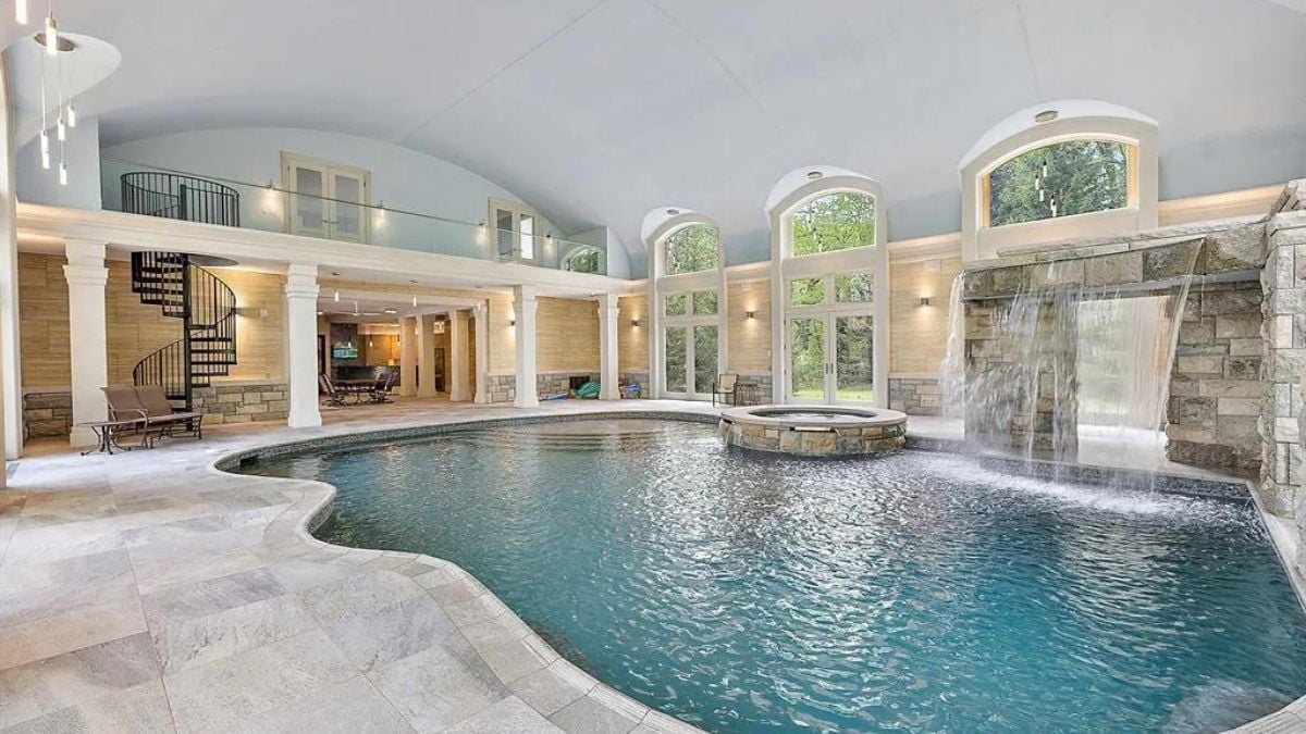 Wide viewpoint of the pool with spiral staircase for the upper floor